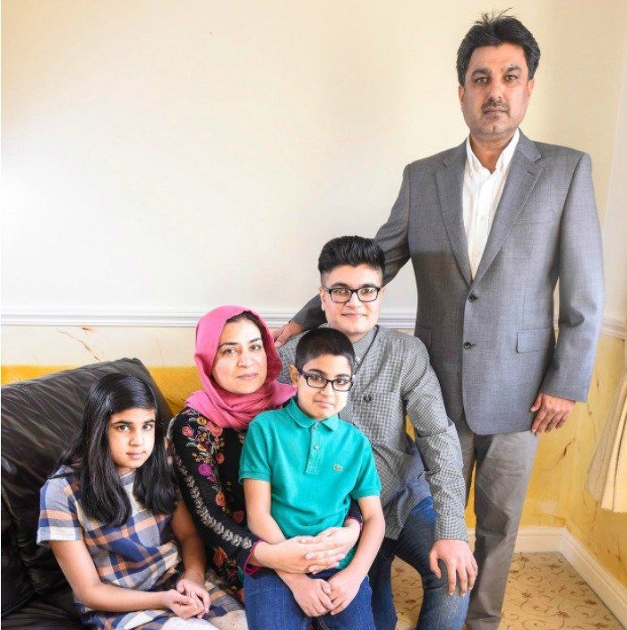 A family posing for a picture in a living room
