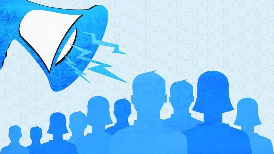 A group of people are standing in front of a megaphone.