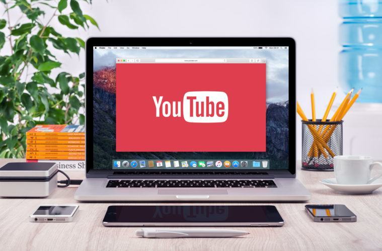 A laptop with a youtube logo on the screen