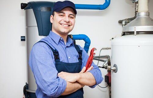 Tankless Water Heater — Plumber beside Water Heater in Carrollton, TX Tankless Water Heater — Plumber beside Water Heater in Carrollton, TX