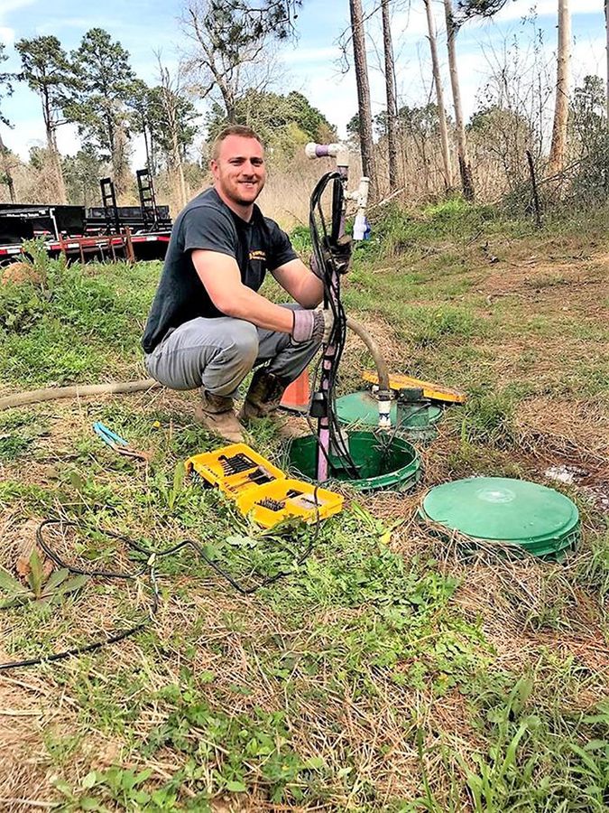 Worker using Measuring Equipment for Septic System