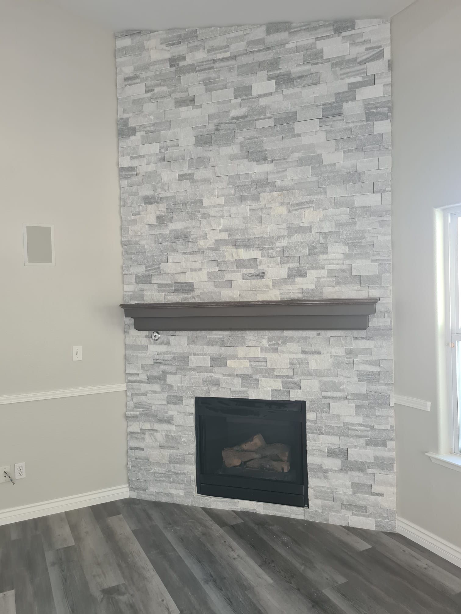 There is a fireplace in the corner of the room.