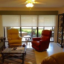 A living room filled with furniture and a ceiling fan