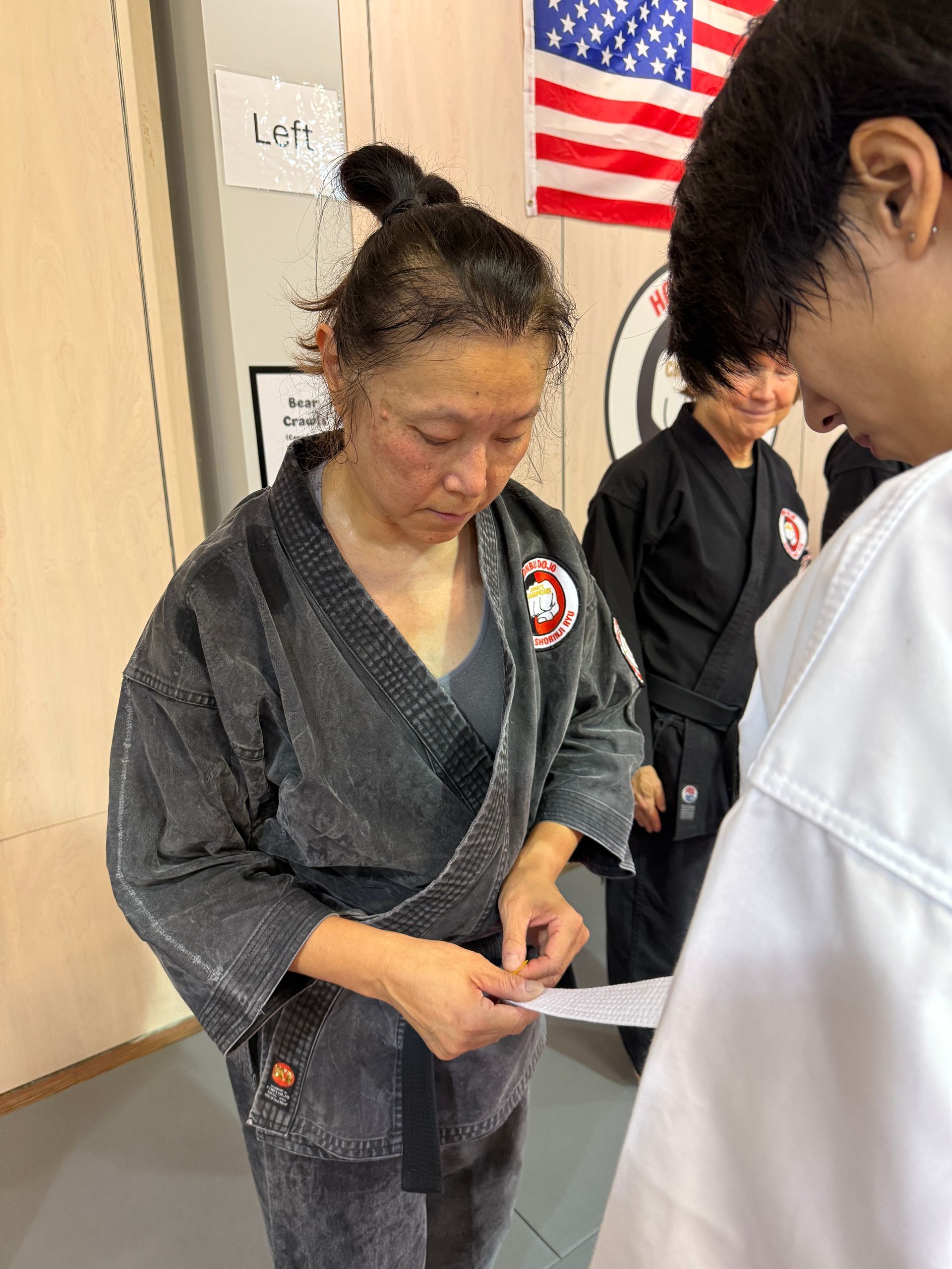 Four men in athletic gear, posing for a photo in a gym.
