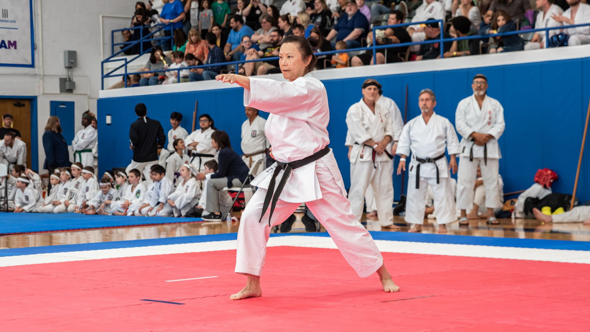 Two people practicing Brazilian Jiu-Jitsu on a mat. One is on top, applying a hold.