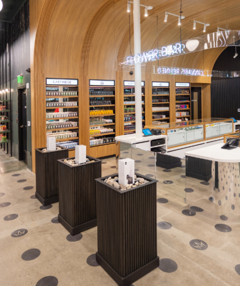 Interior of a retail store with wooden shelves, display cases, and floor-to-ceiling products.
