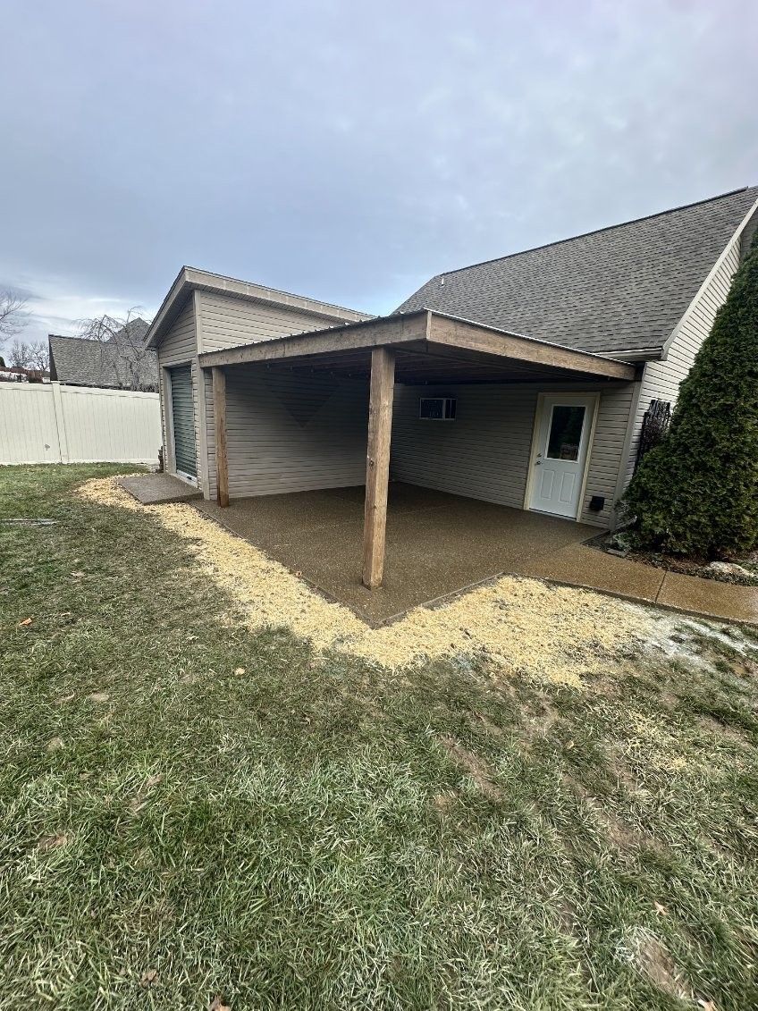 A house with a covered porch in the backyard.