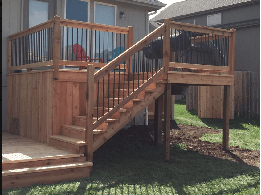 A wooden deck with stairs leading up to it