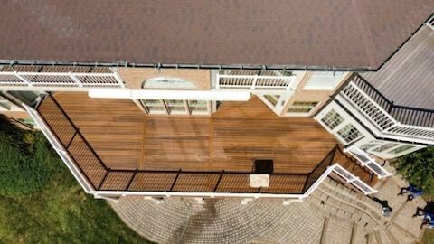 An aerial view of a large house with a wooden deck.
