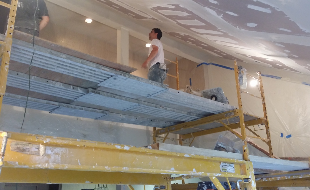 Drywall Plastering Company — Man Checking The Ceiling in East Providence, RI