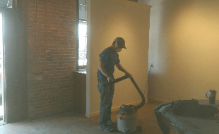 Plaster Contractor — Man with Vacuum Cleaner in East Providence, RI