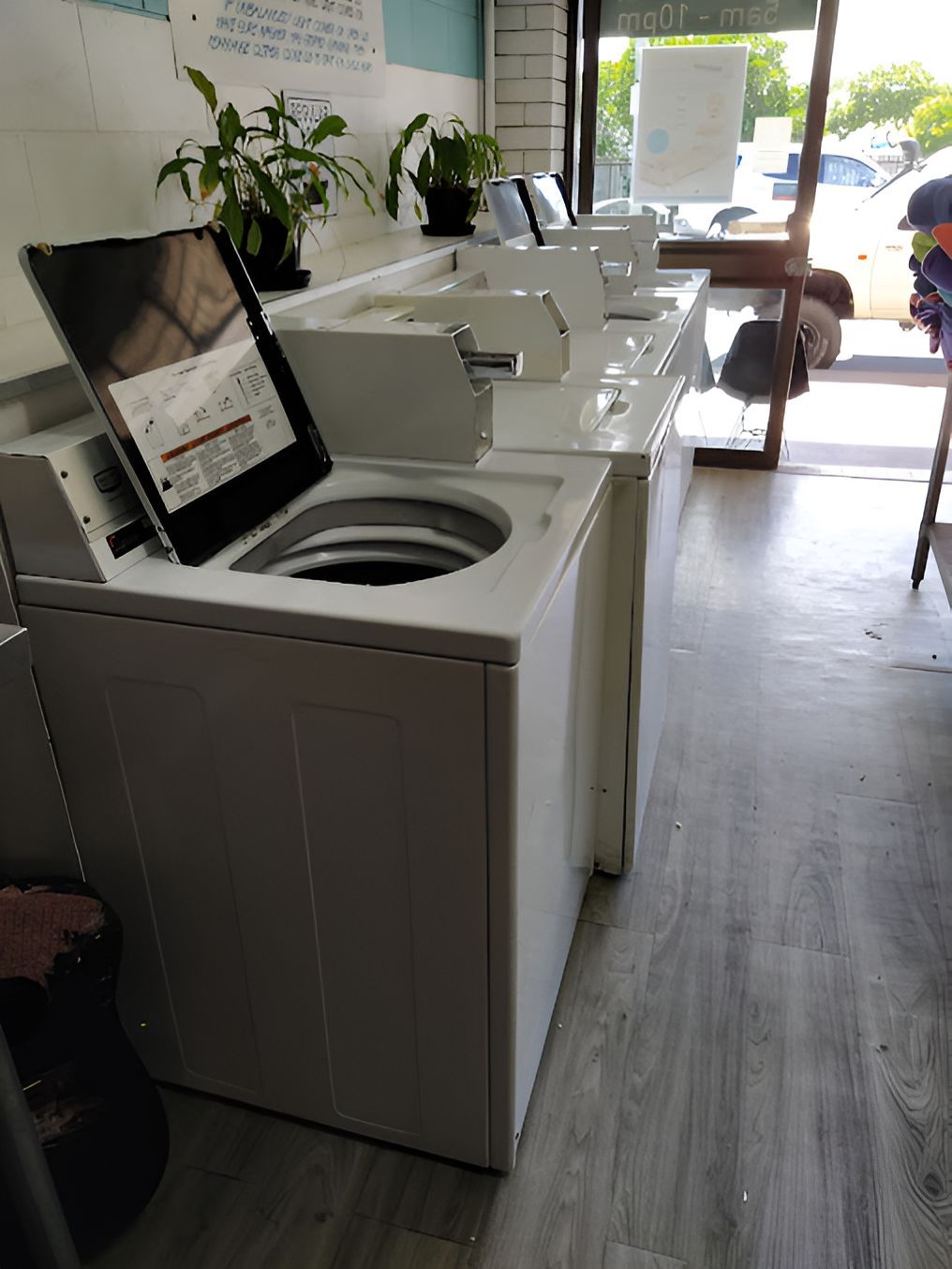 A Row Of White Washing Machines Are Lined Up In A Laundromat — The Cotton Tree Laundry In Cotton Tree, QLD