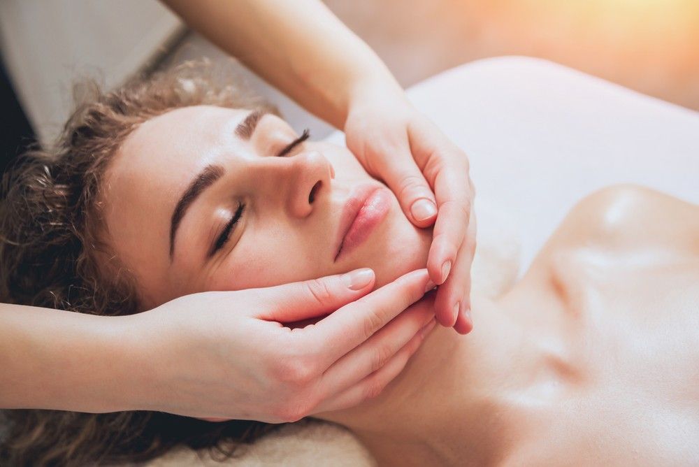 A Woman is Getting a Facial Massage at a Spa — Organic Beauty by Kessie in Yeppoon, QLD