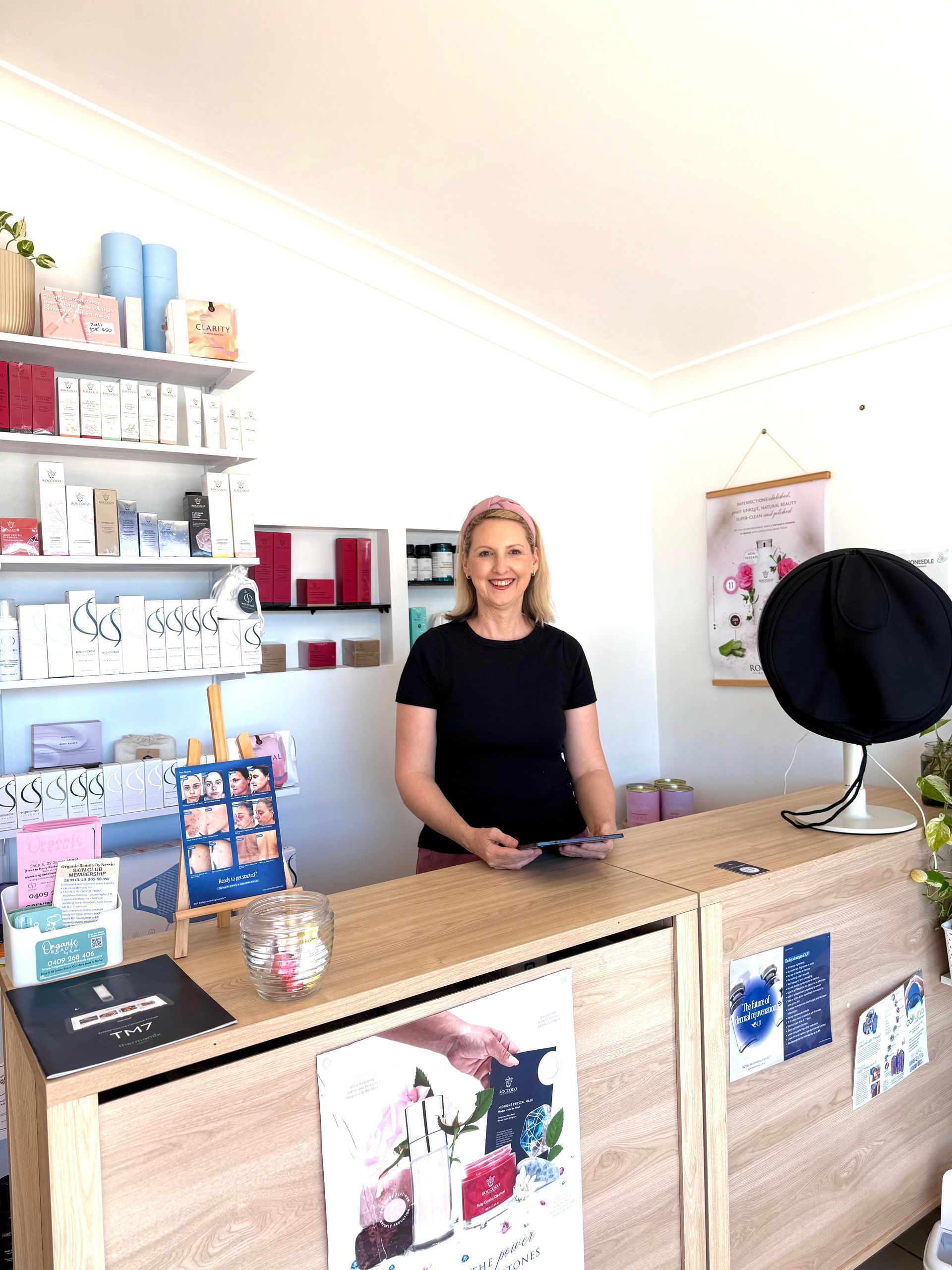 A Woman is Sitting in a Chair Holding a Cup of Coffee — Organic Beauty by Kessie in Yeppoon, QLD