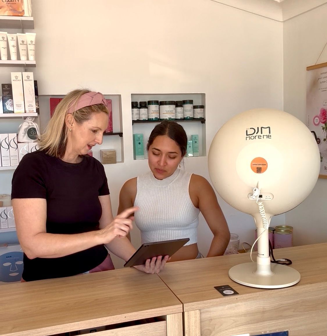 Two Women Are Looking at a Tablet With a Skin Analysis Test — Organic Beauty by Kessie in Yeppoon, QLD