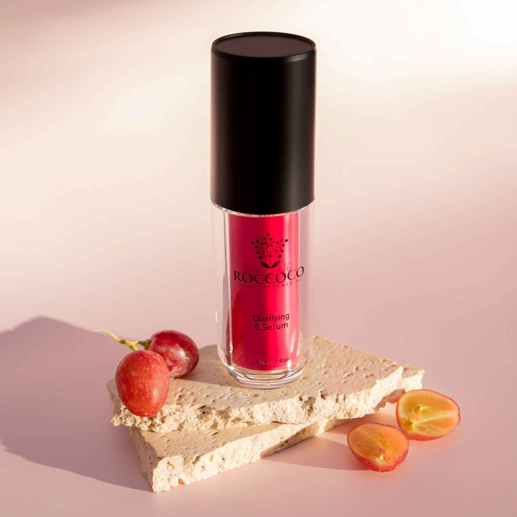 A Bottle of Liquid Lipstick is Sitting on Top of a Piece of Marble Next to Grapes — Organic Beauty by Kessie in Yeppoon, QLD