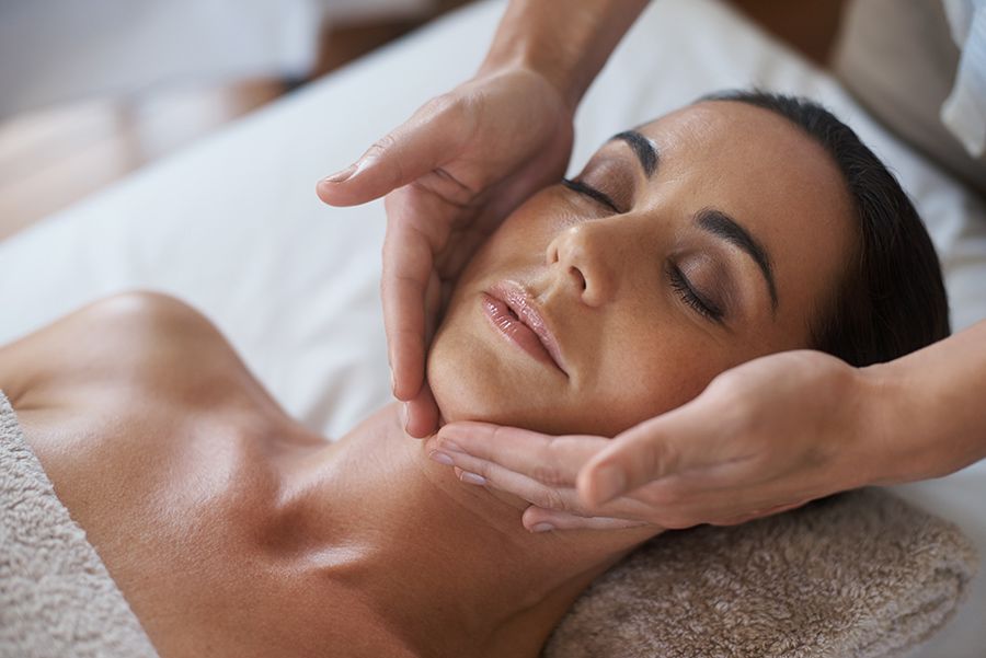 A Woman is Getting a Facial Massage at a Spa — Organic Beauty by Kessie in Yeppoon, QLD