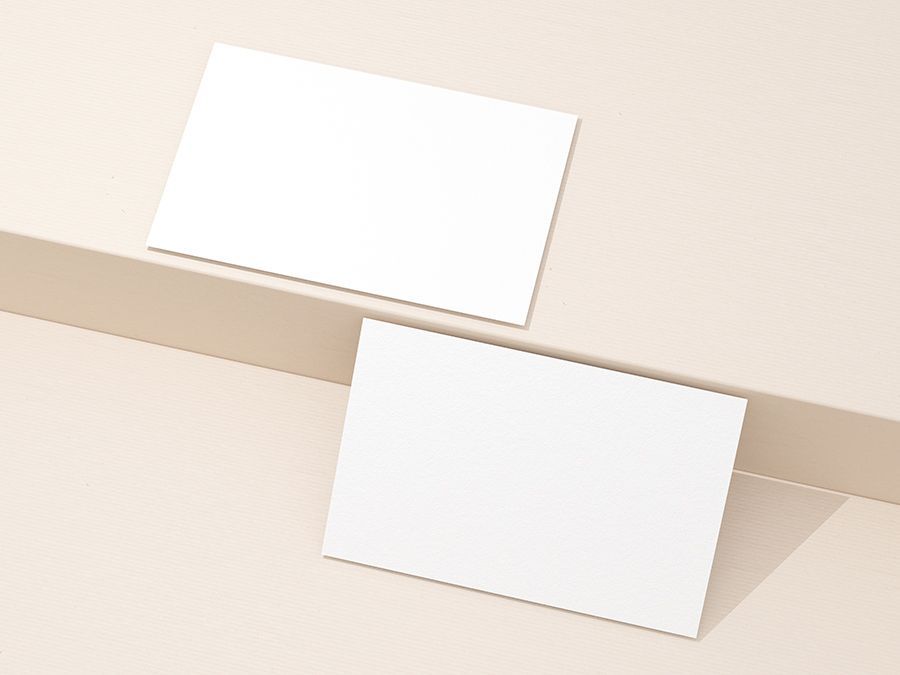 Two White Business Cards Are Sitting on Top of Each Other on a Table — Organic Beauty by Kessie in Yeppoon, QLD