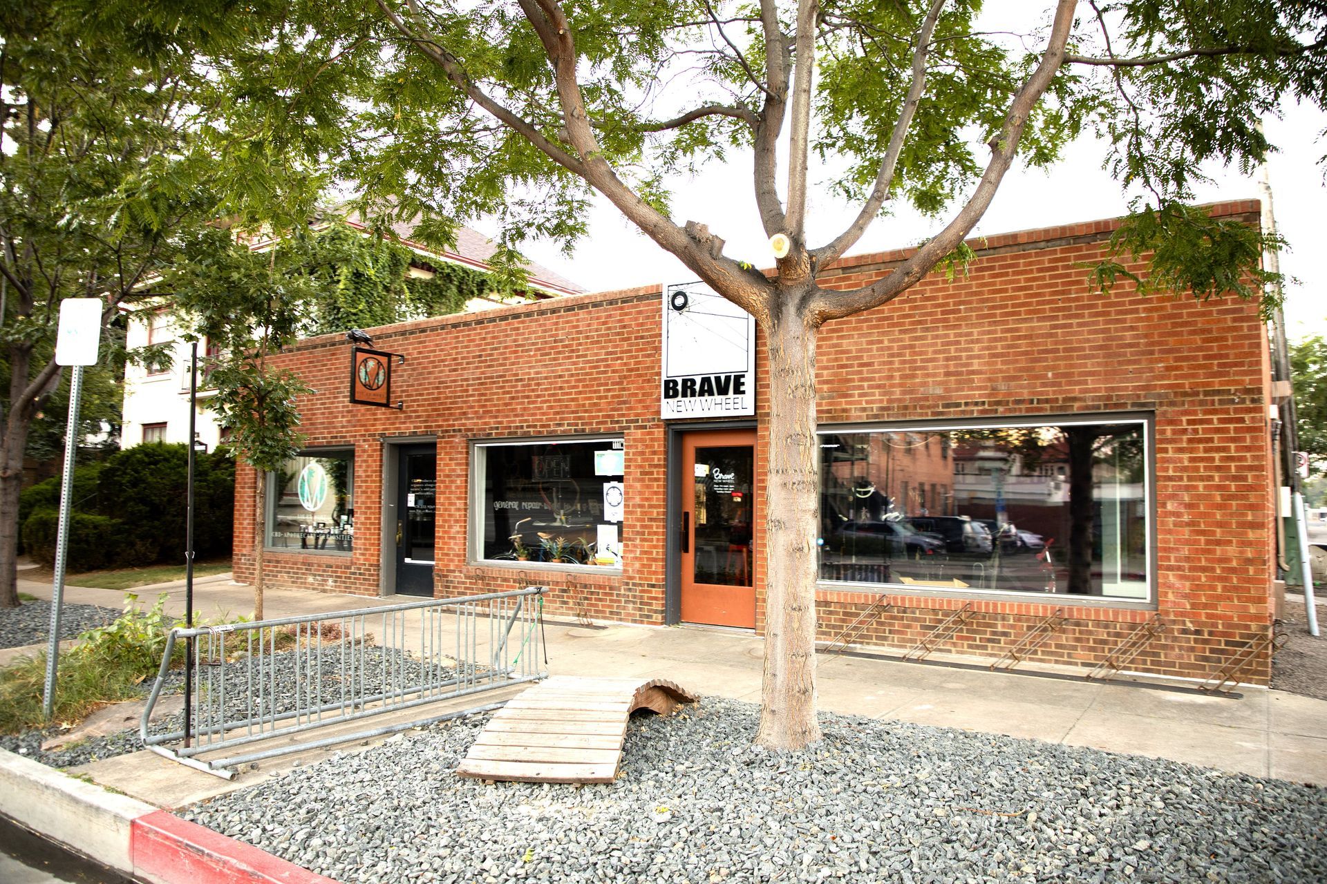 A brick building with a tree in front of it.