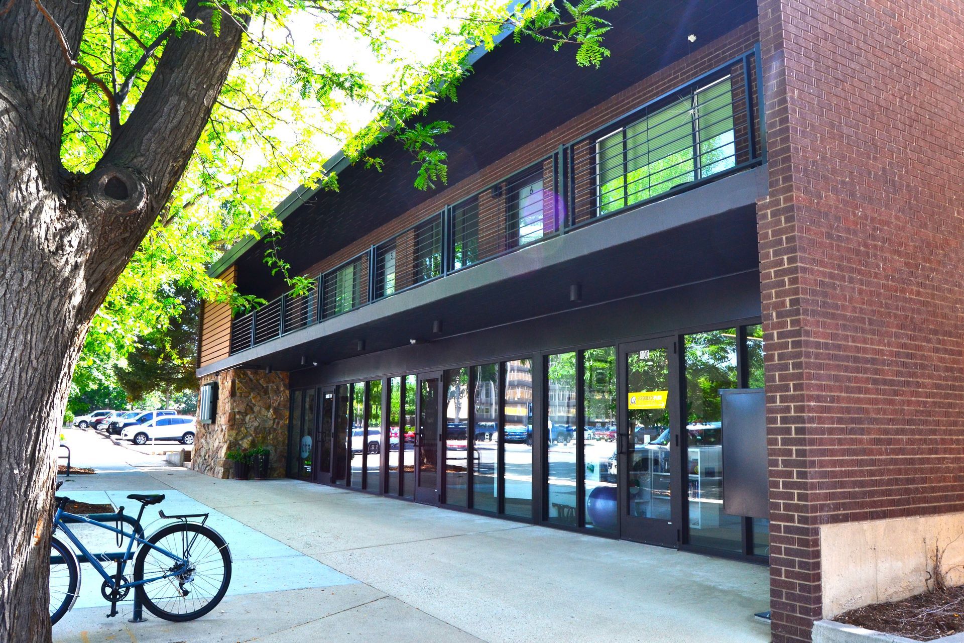 Two bicycles are parked in front of a brick building