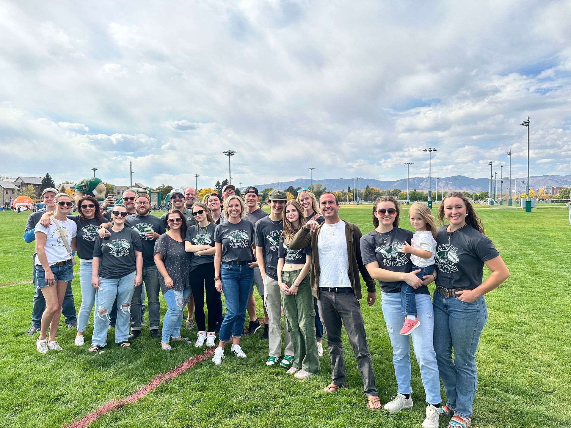 A group of people are posing for a picture in a field.