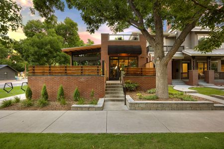 A brick house with a tree in front of it