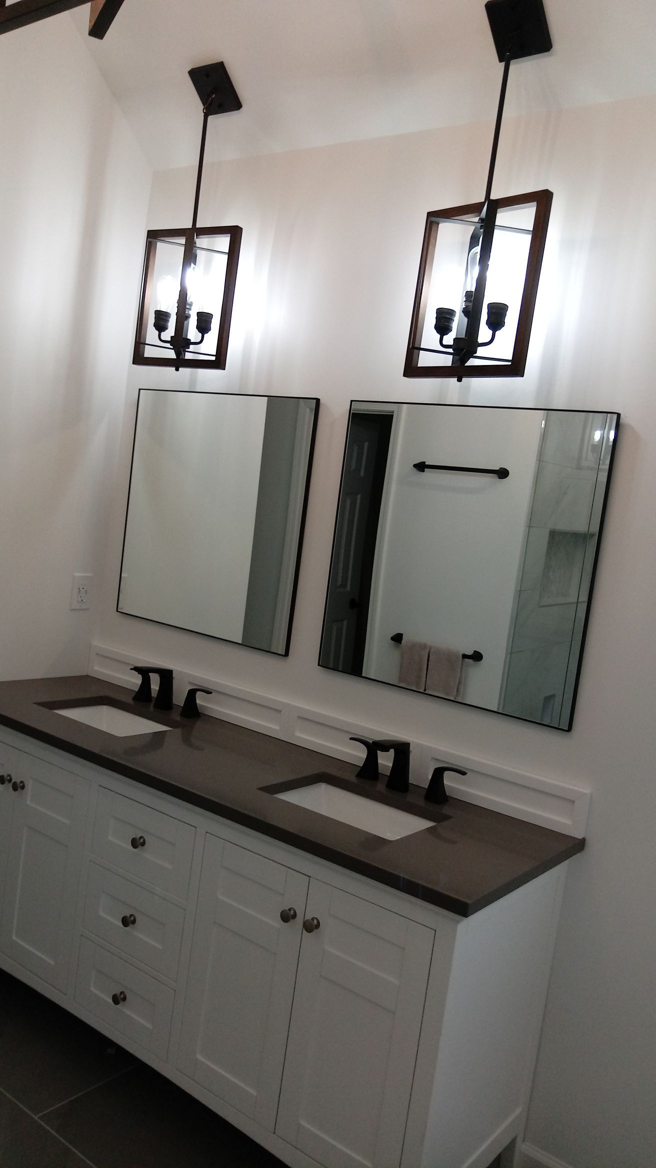A bathroom with two sinks and two mirrors.