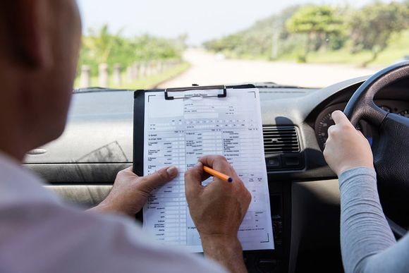 traffic instructor filling a check list