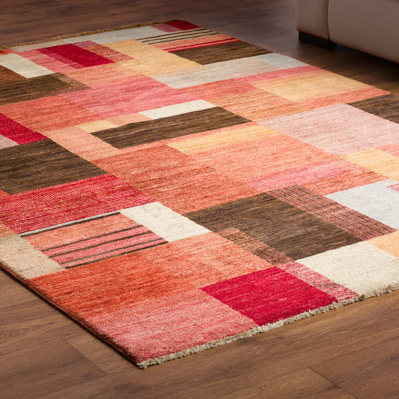 a colorful rug is on a wooden floor