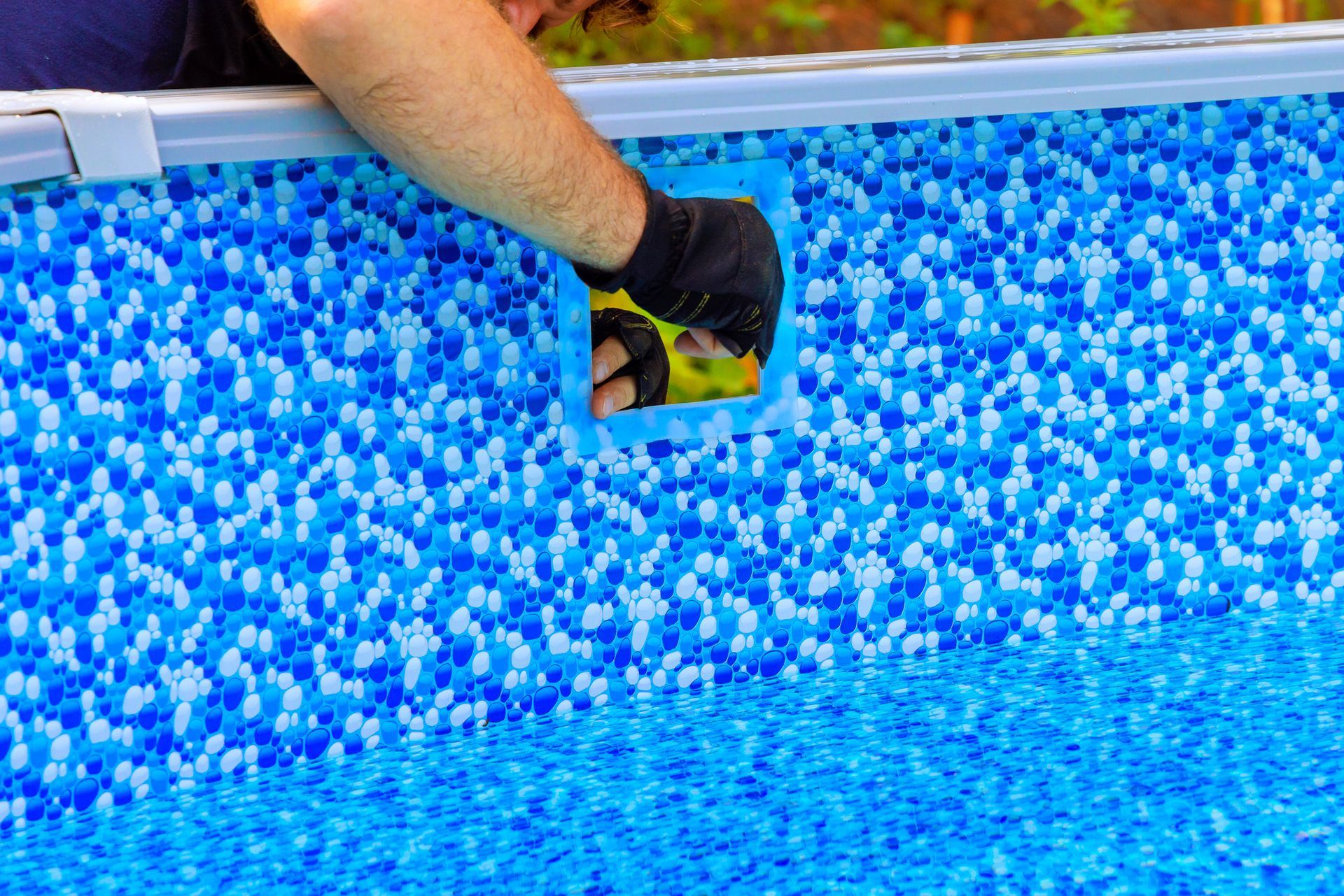 Installing a filtration system for a new backyard above ground swimming pool.