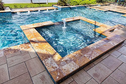 A large swimming pool with a fountain in the middle of it.