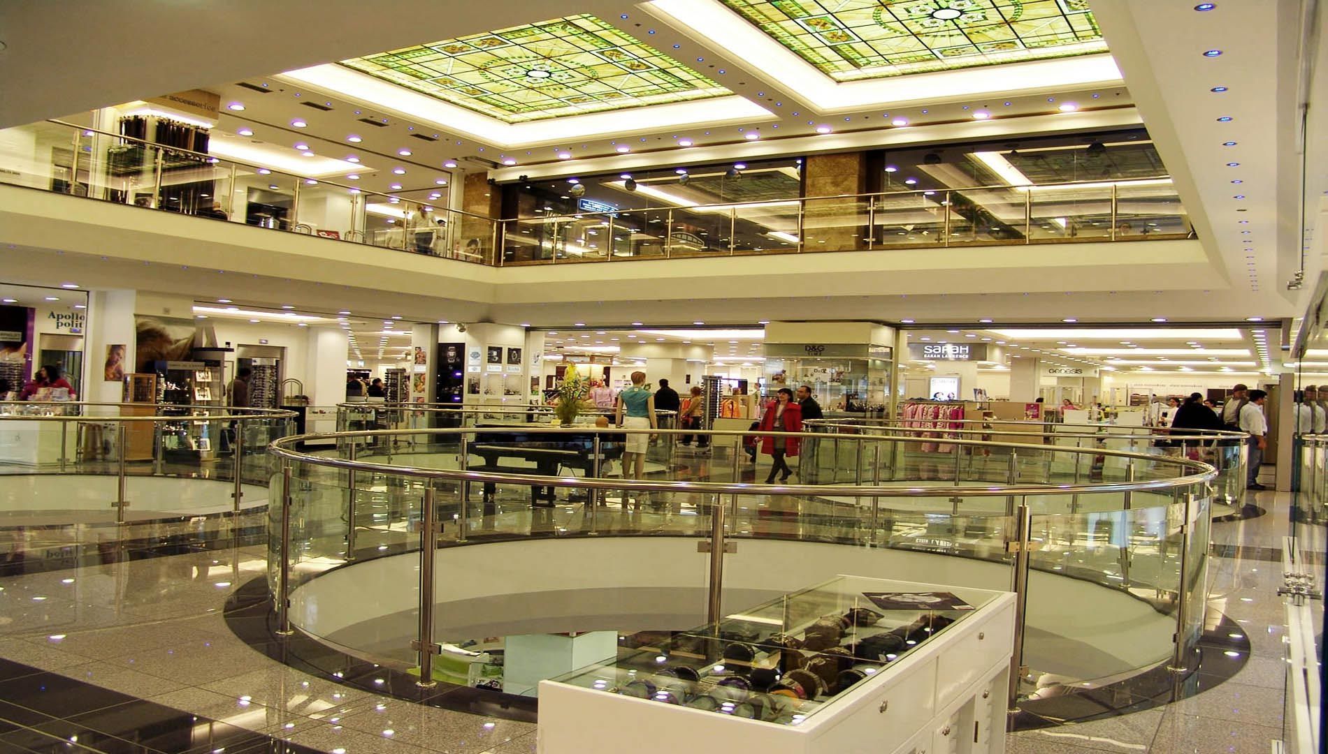 A large shopping mall with a stained glass ceiling