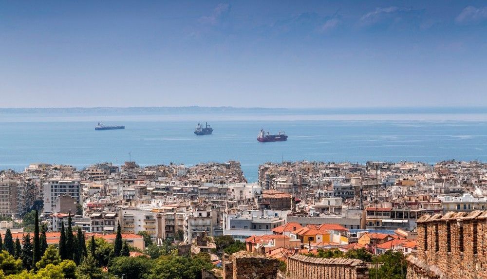 An aerial view of a city with a large body of water in the background.