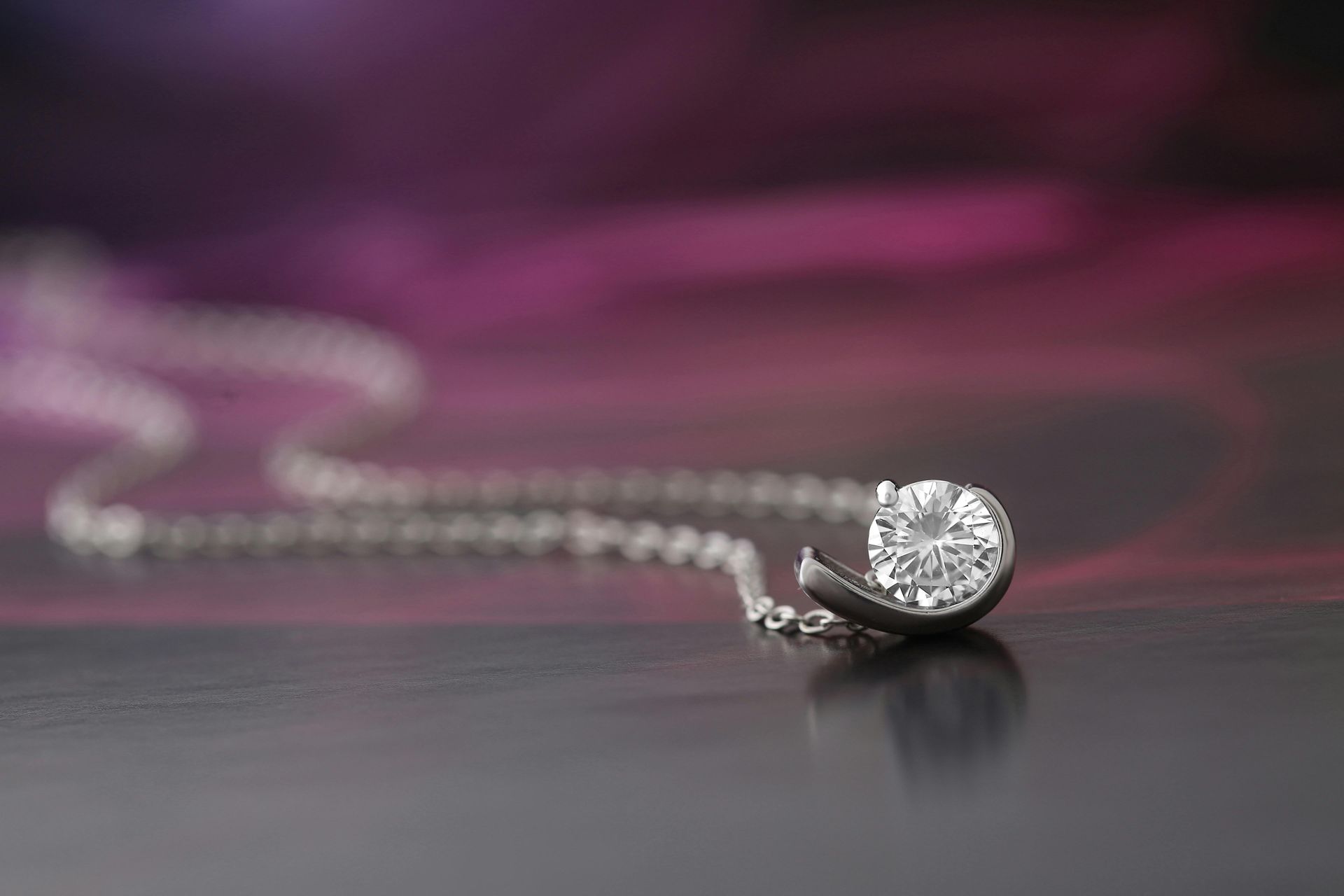 A close up of a diamond necklace on a table.