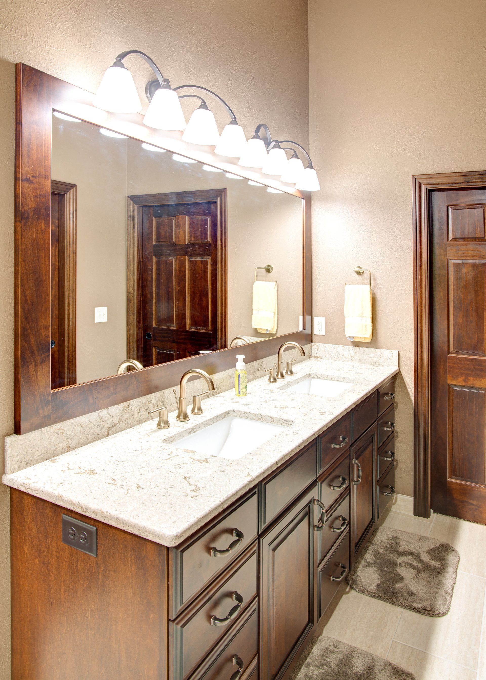 A bathroom with two sinks and a large mirror