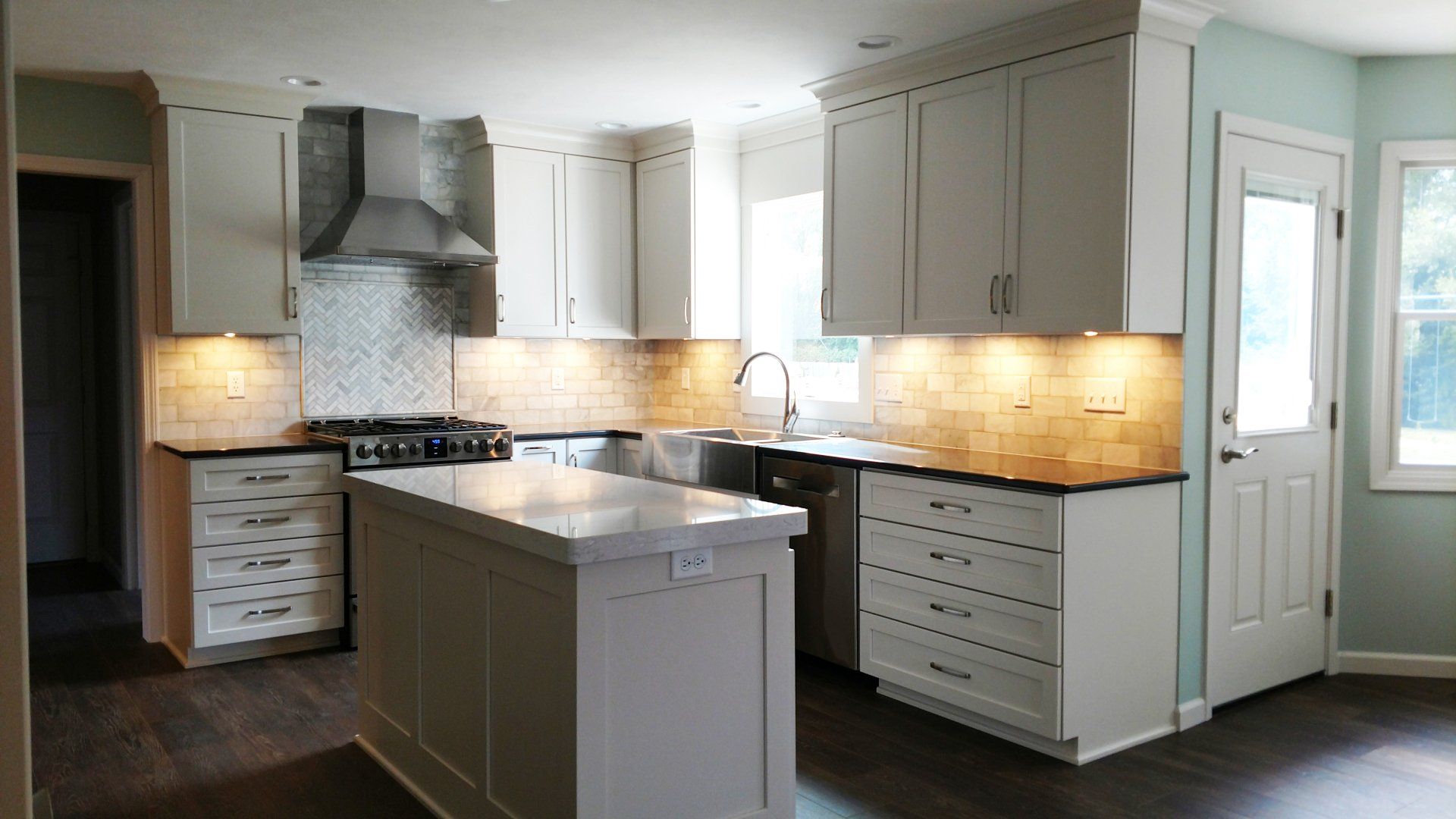 A kitchen with white cabinets and stainless steel appliances