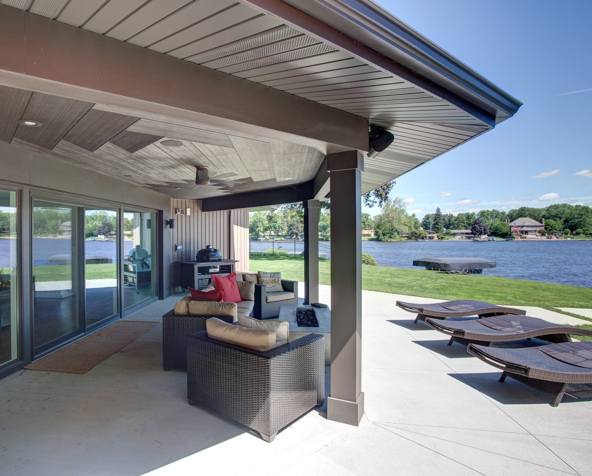 A covered patio with a view of a lake