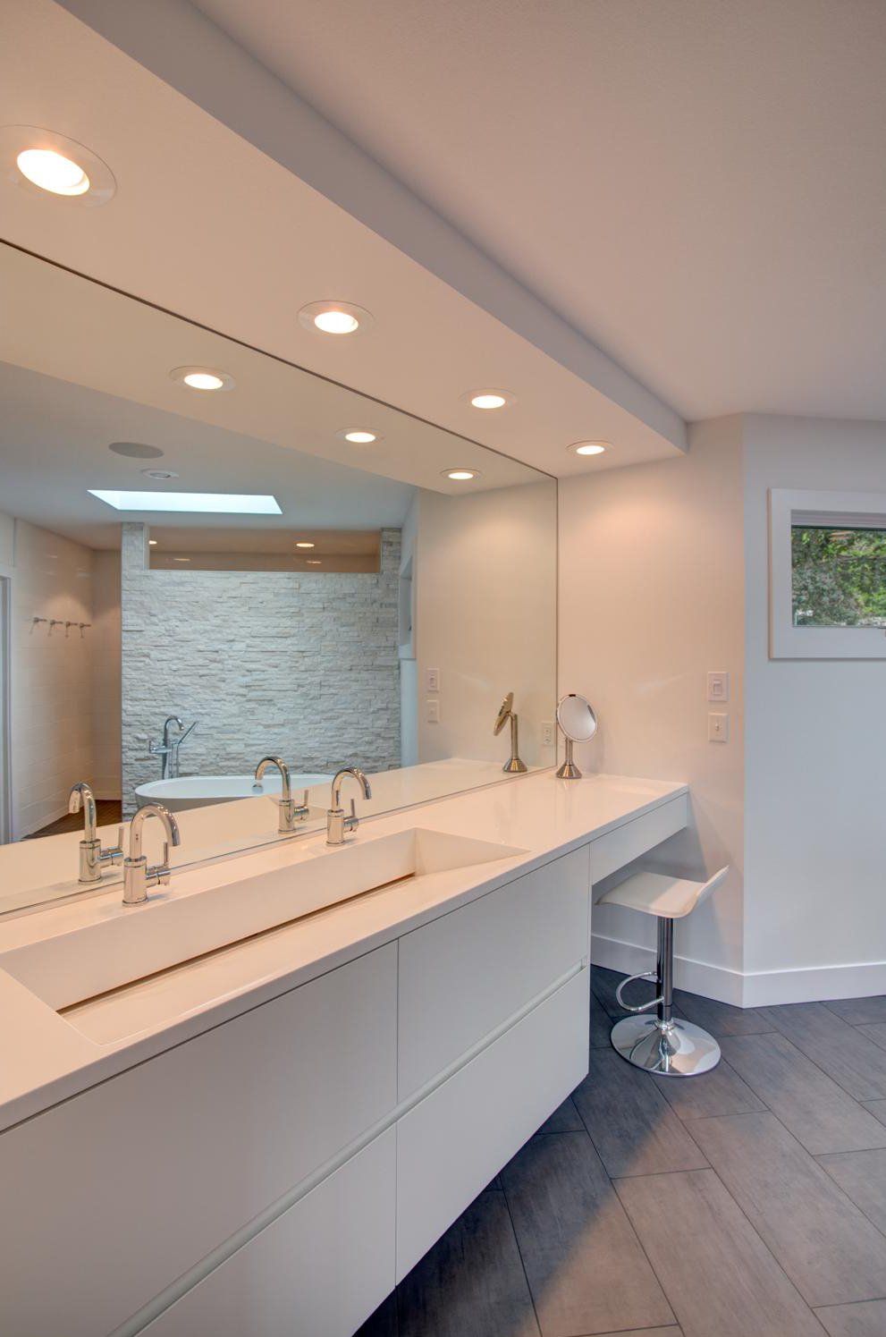 A bathroom with two sinks and a large mirror