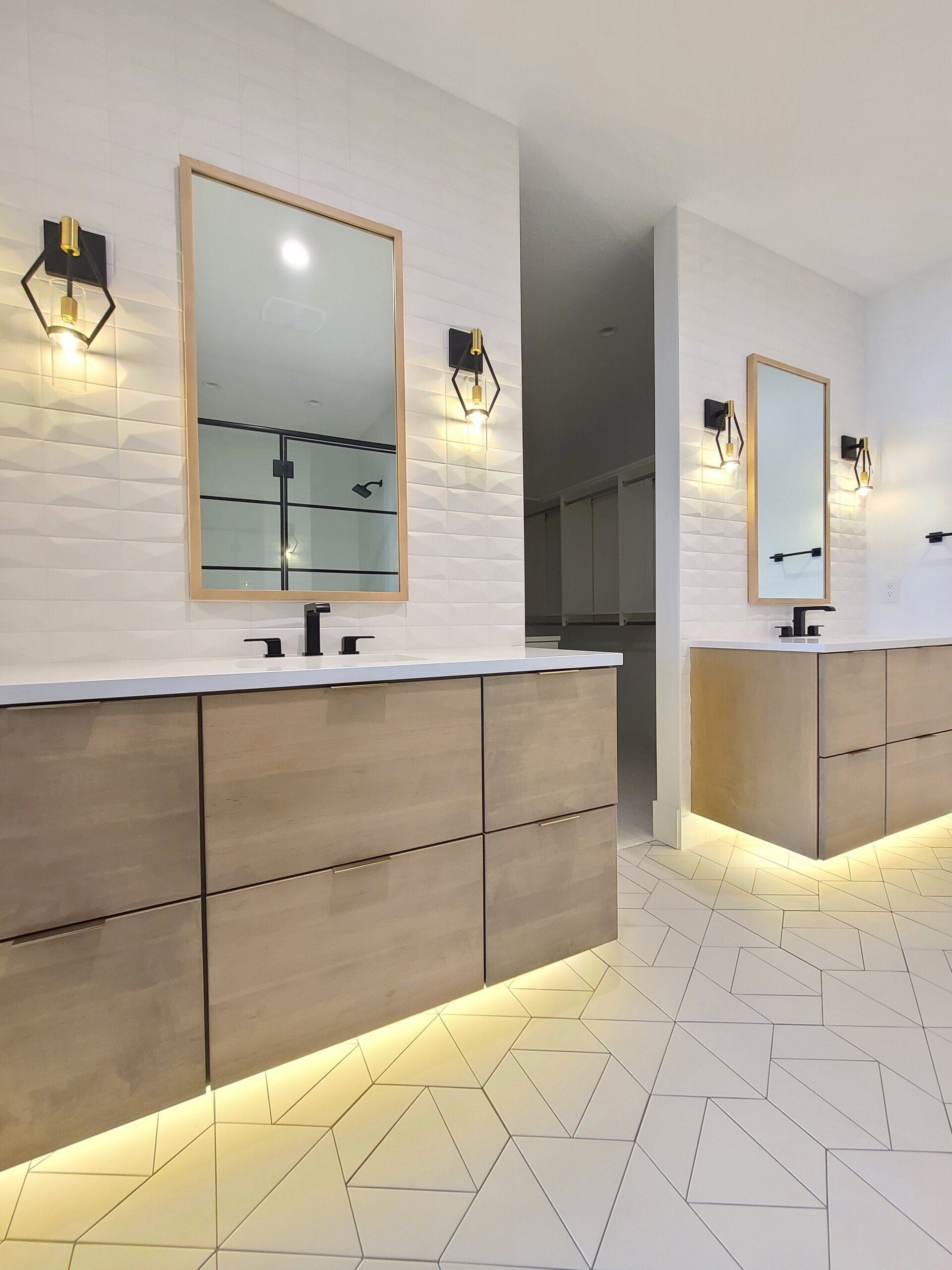 A bathroom with two sinks and two mirrors