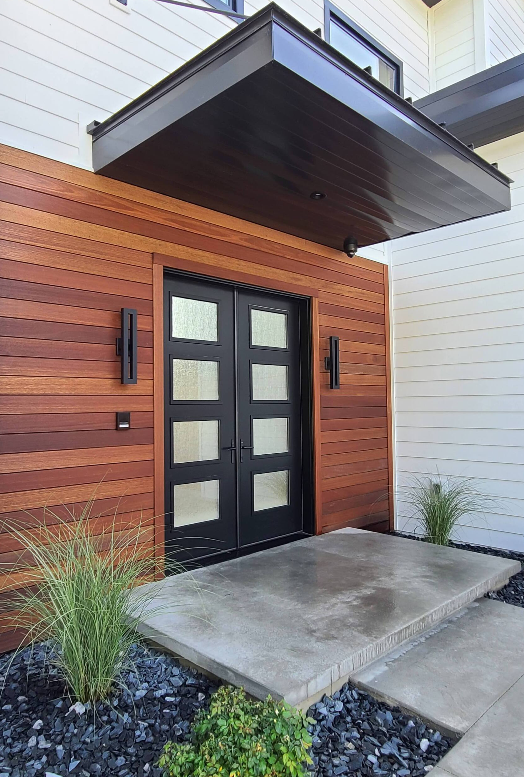 The front door of a house with a canopy over it.