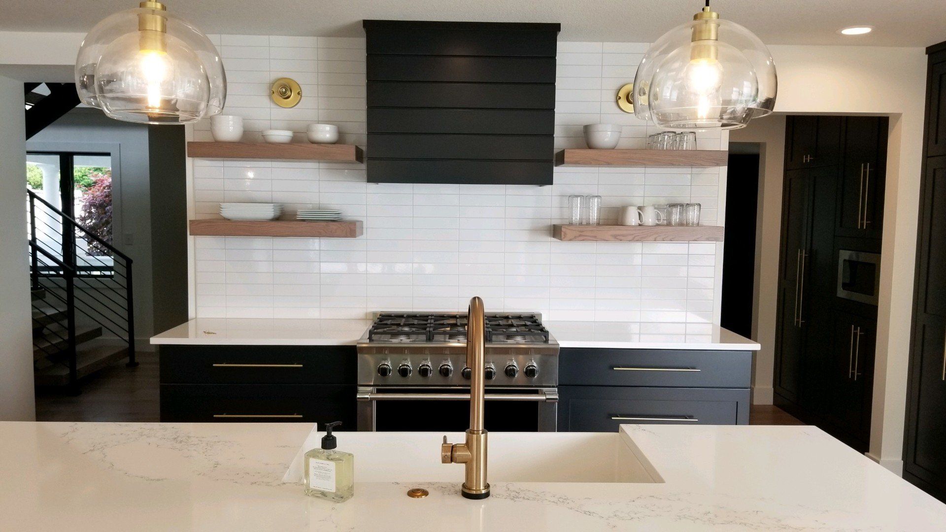 A kitchen with a stove top oven and a sink