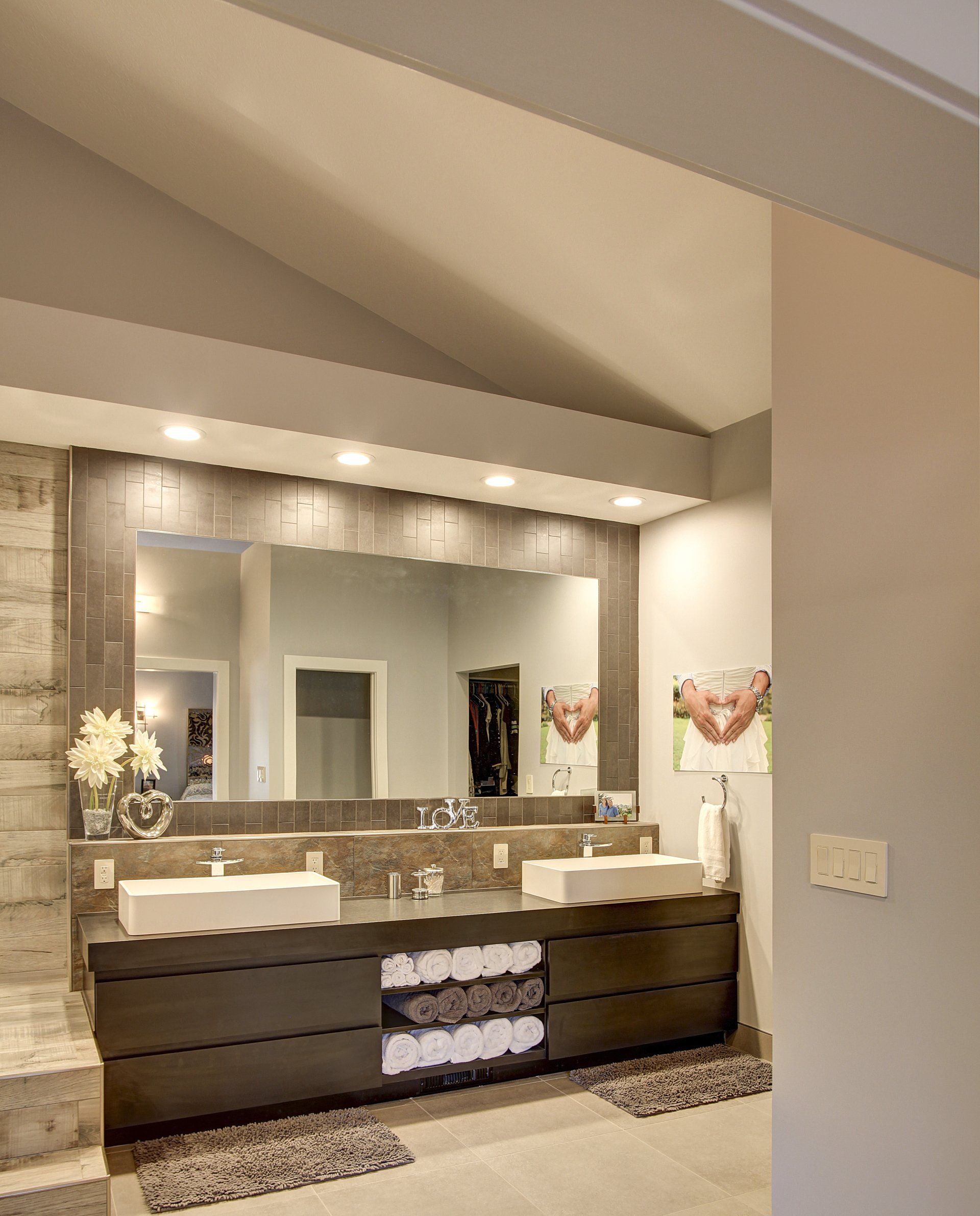 A bathroom with two sinks and a large mirror