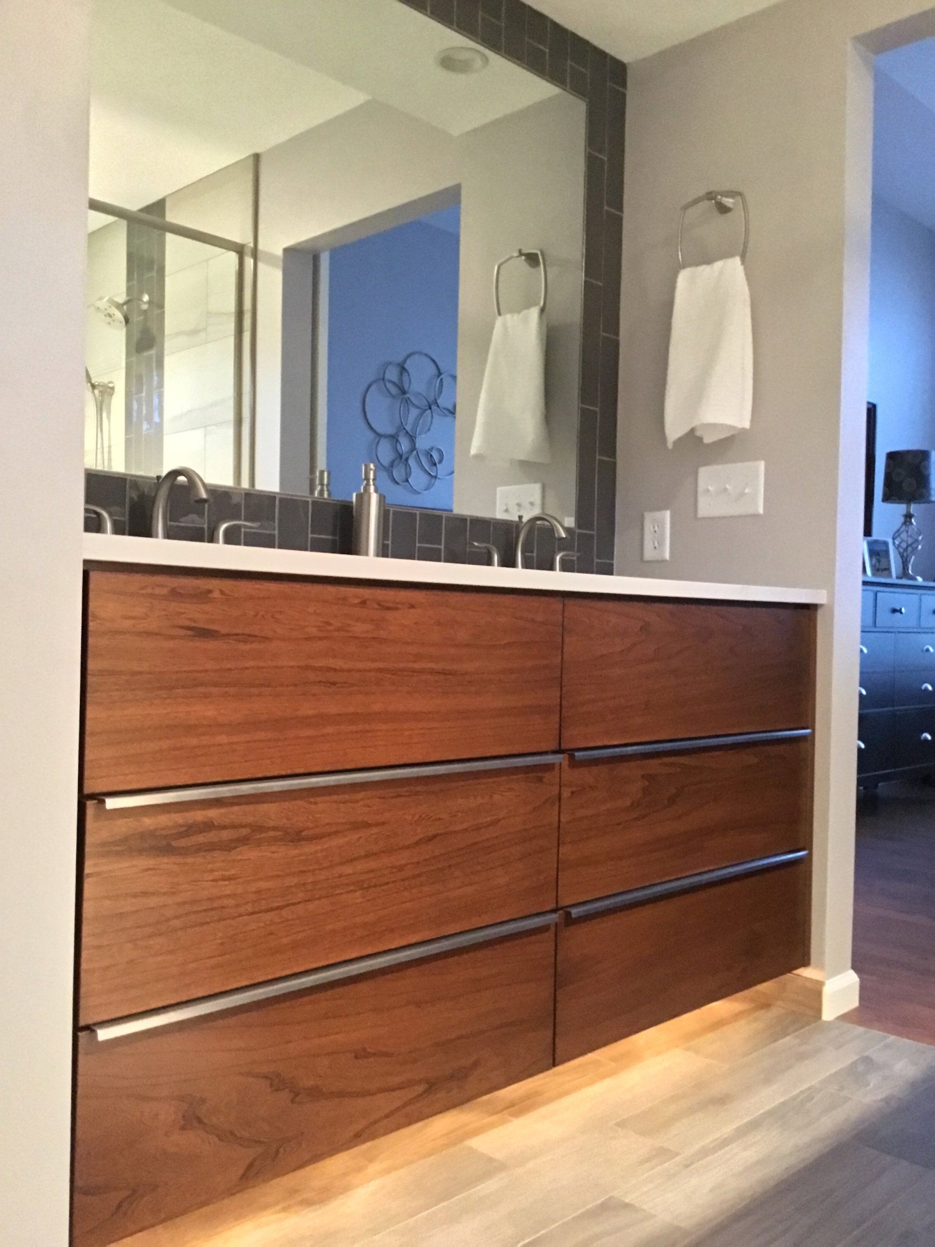 A bathroom with two sinks and a large mirror