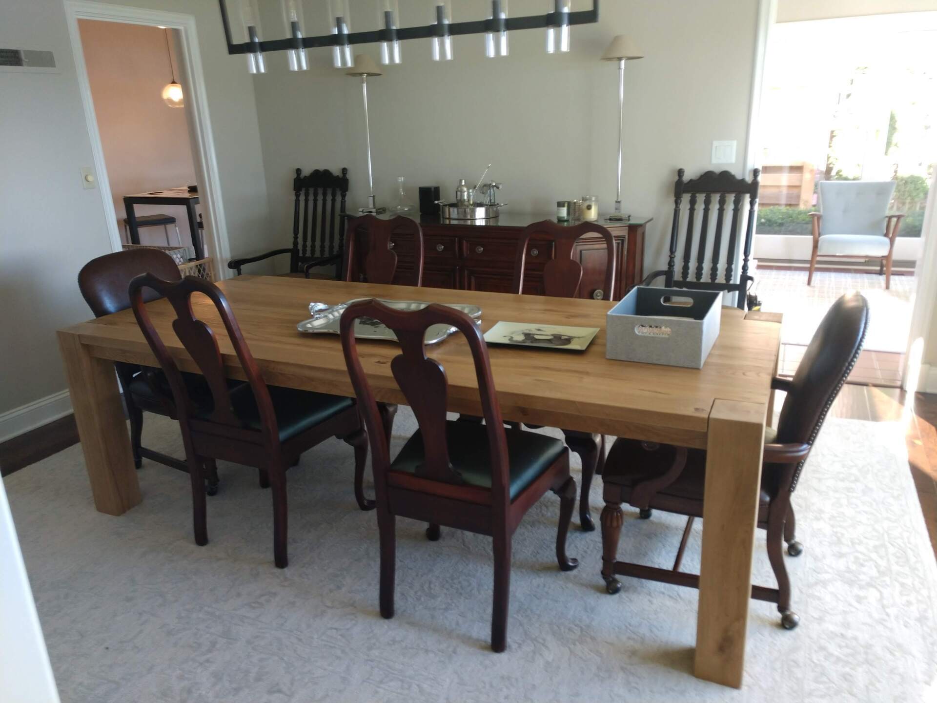 A dining room with a wooden table and chairs