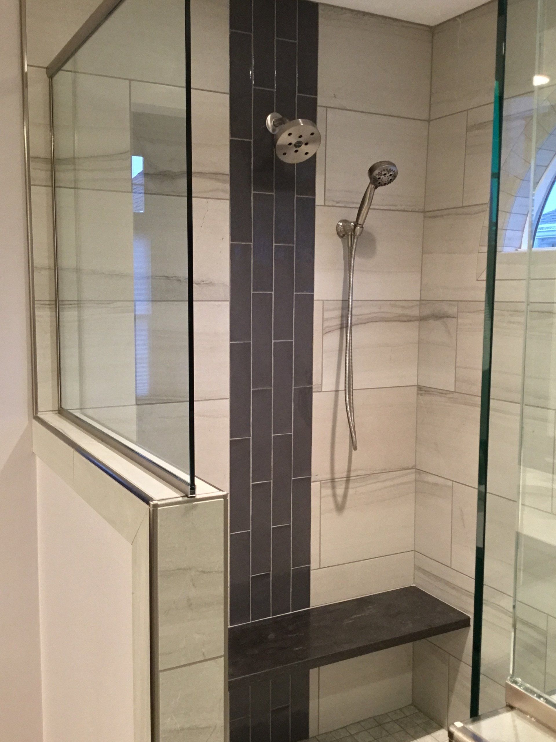 A bathroom with a shower and a bench in it