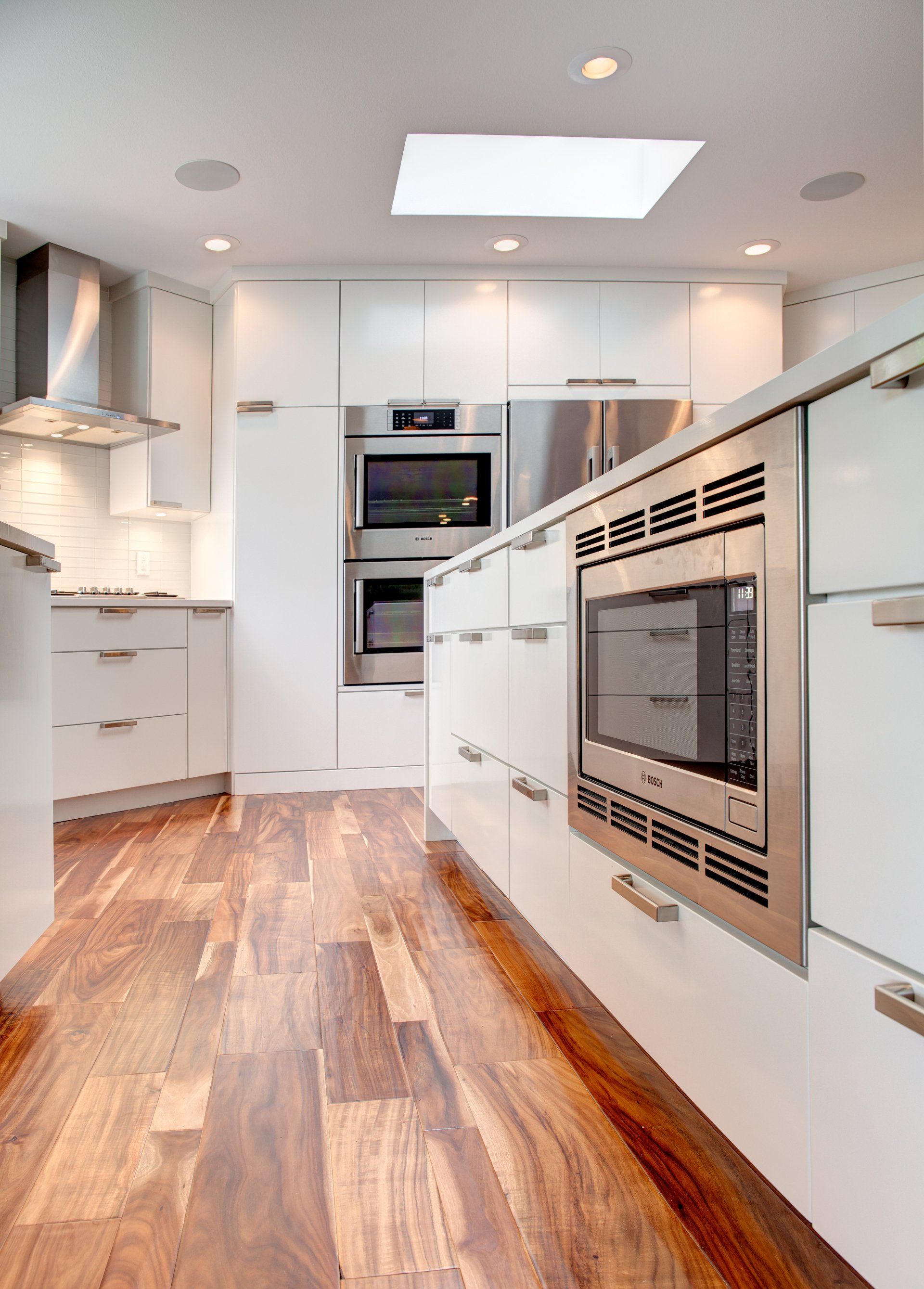 A kitchen with white cabinets and stainless steel appliances