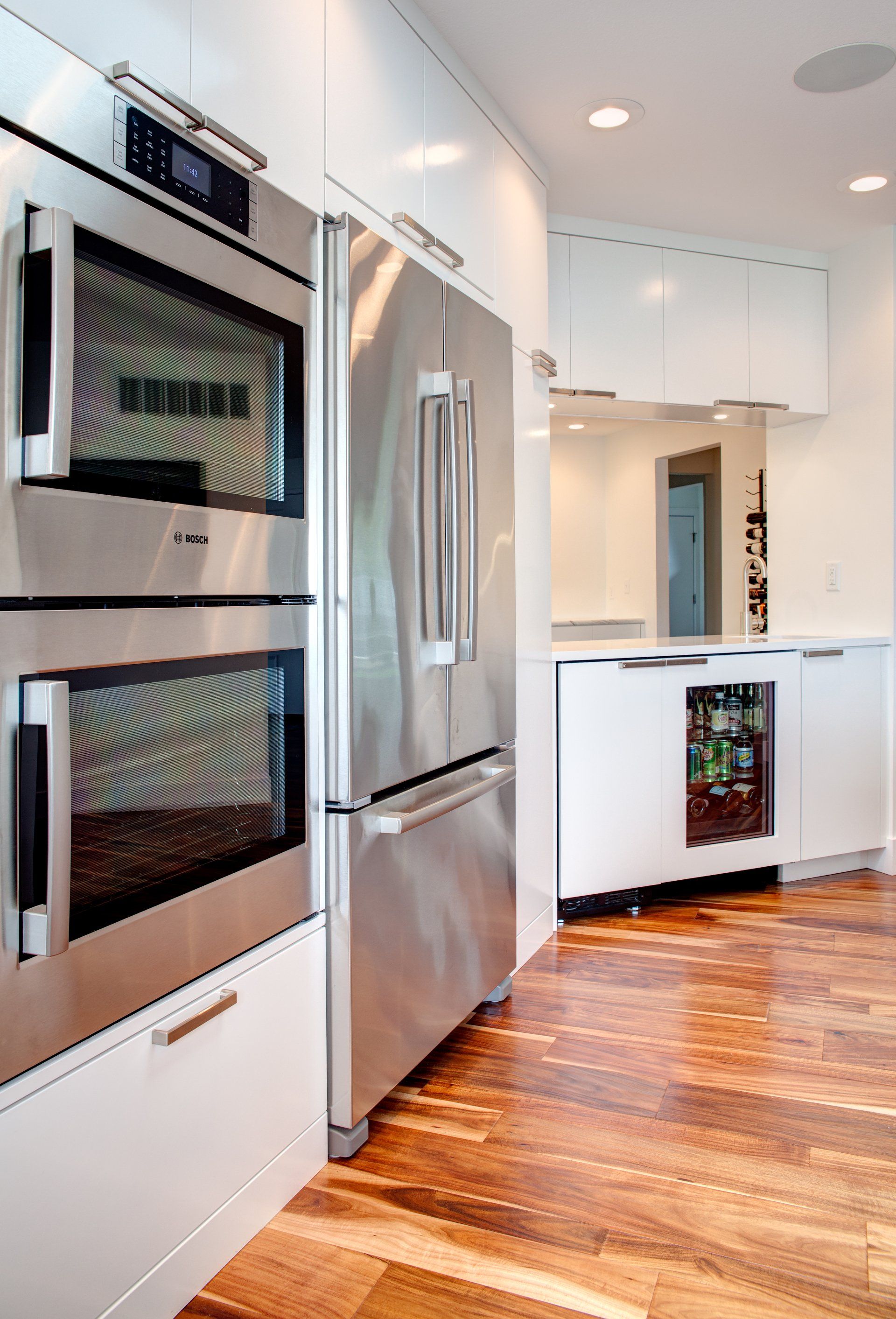 A kitchen with stainless steel appliances and white cabinets