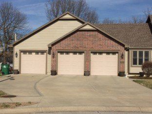 House with front garage — Garage door company in Harrisonville, MO