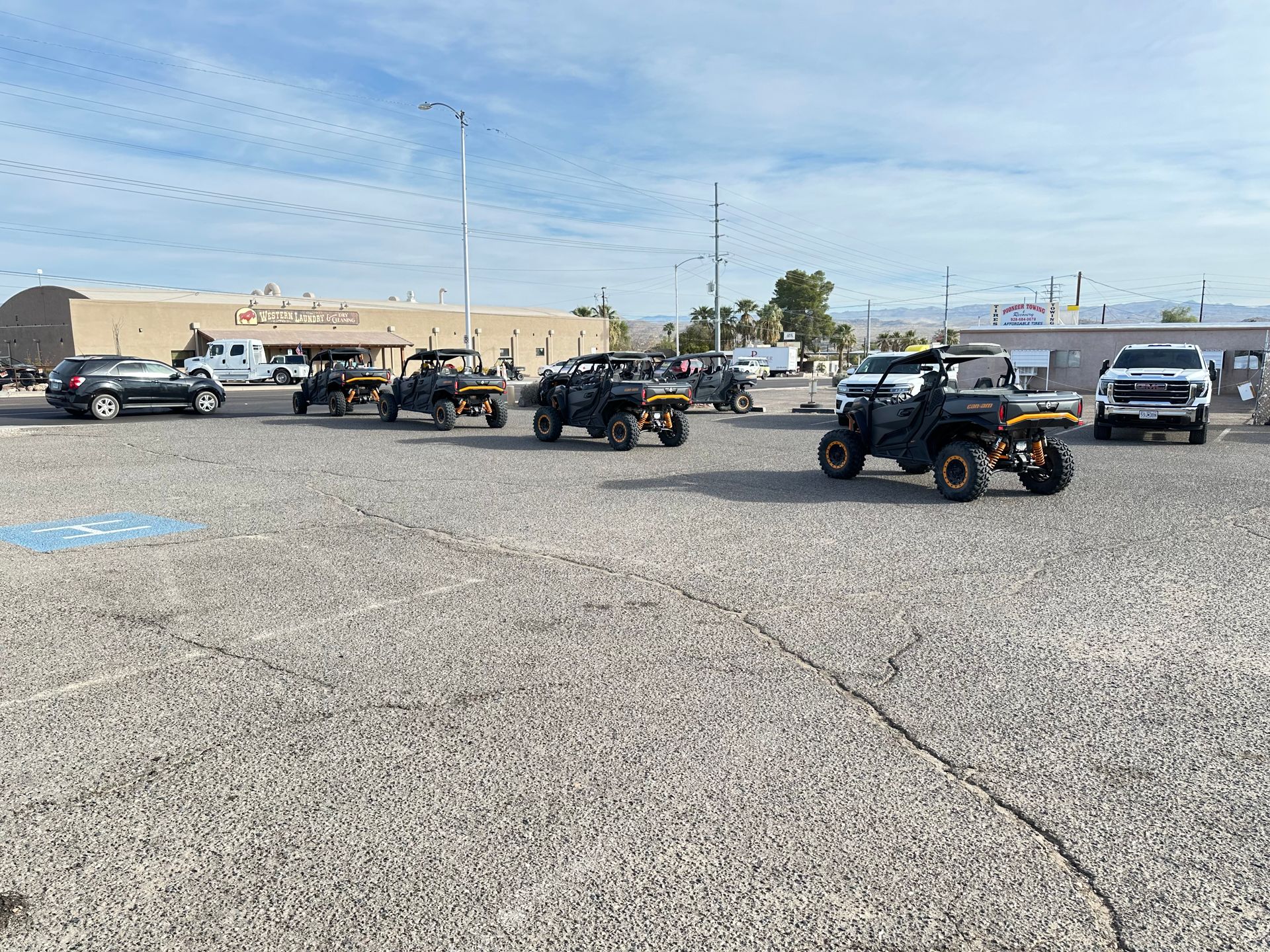 A group of atvs are parked in a parking lot.