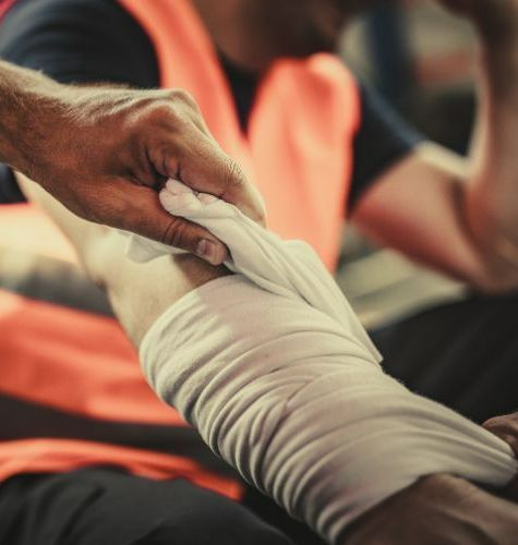 an image of a hand bandaging an arm